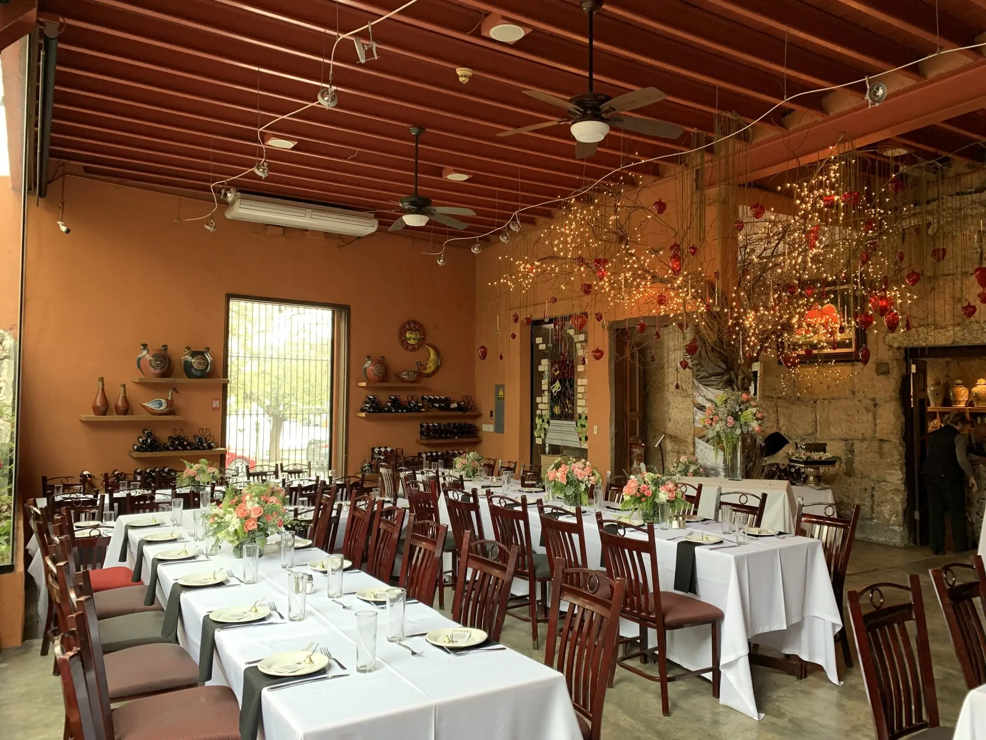 The Main Dining Room set with long tables, under the warm hanging lights