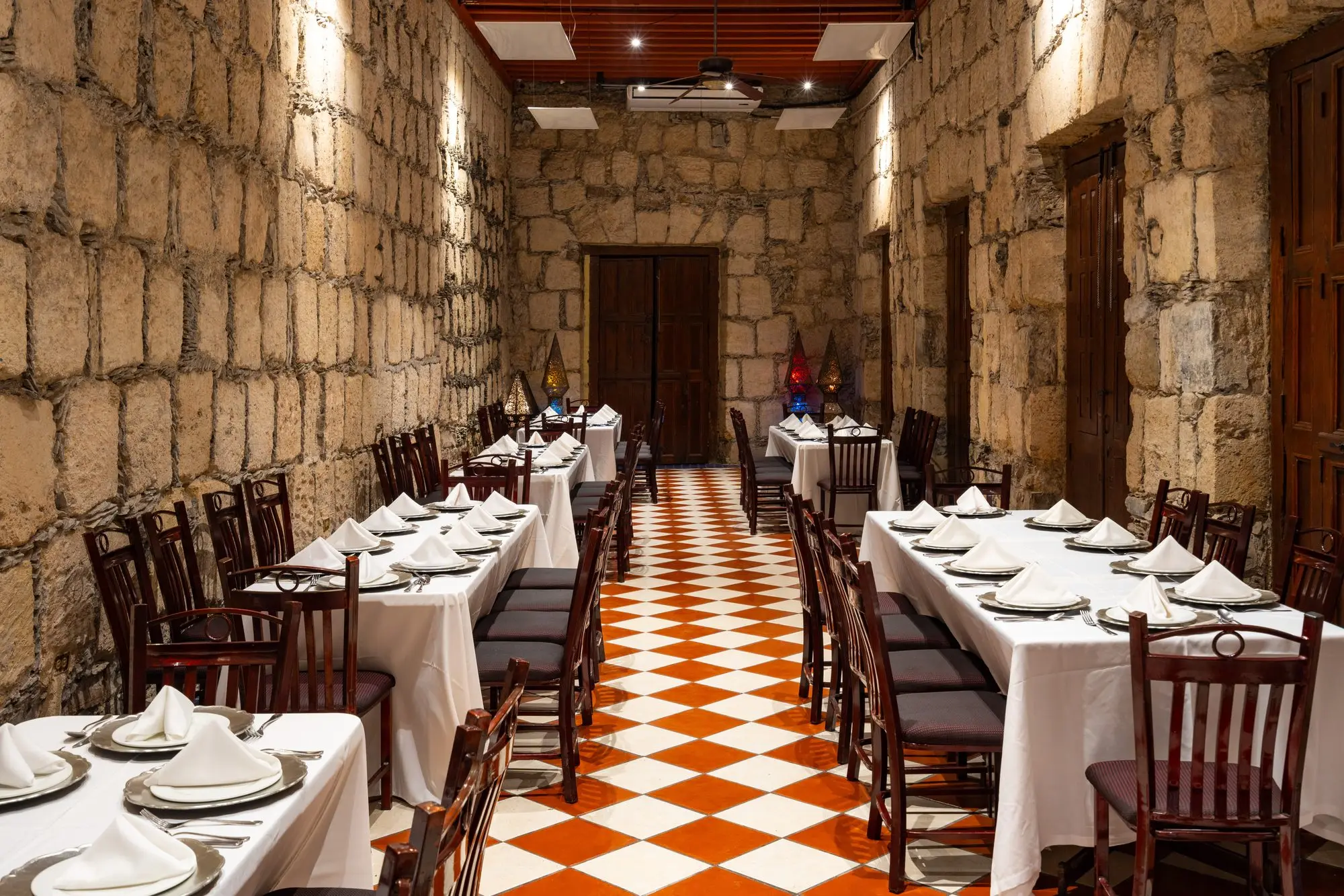 Salón Romancera with two long tables set on the checkerboard floor