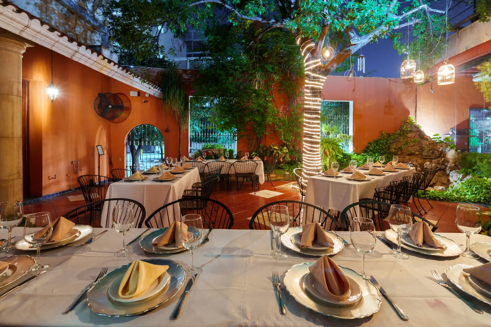 The Garden set at night, with the adobe walls and the light cages