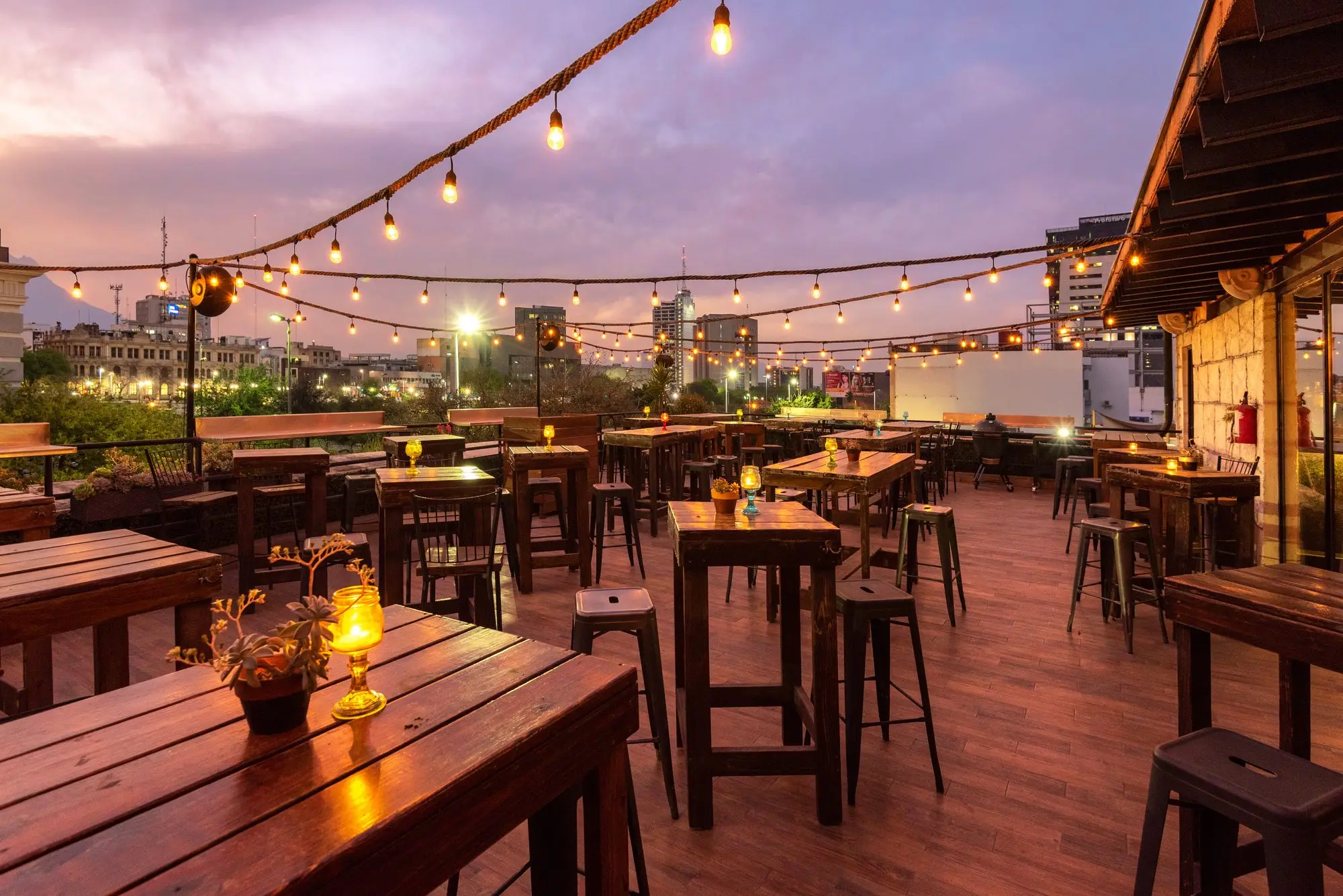 Terraza Coss set under the mauve sunset sky, with the city in front