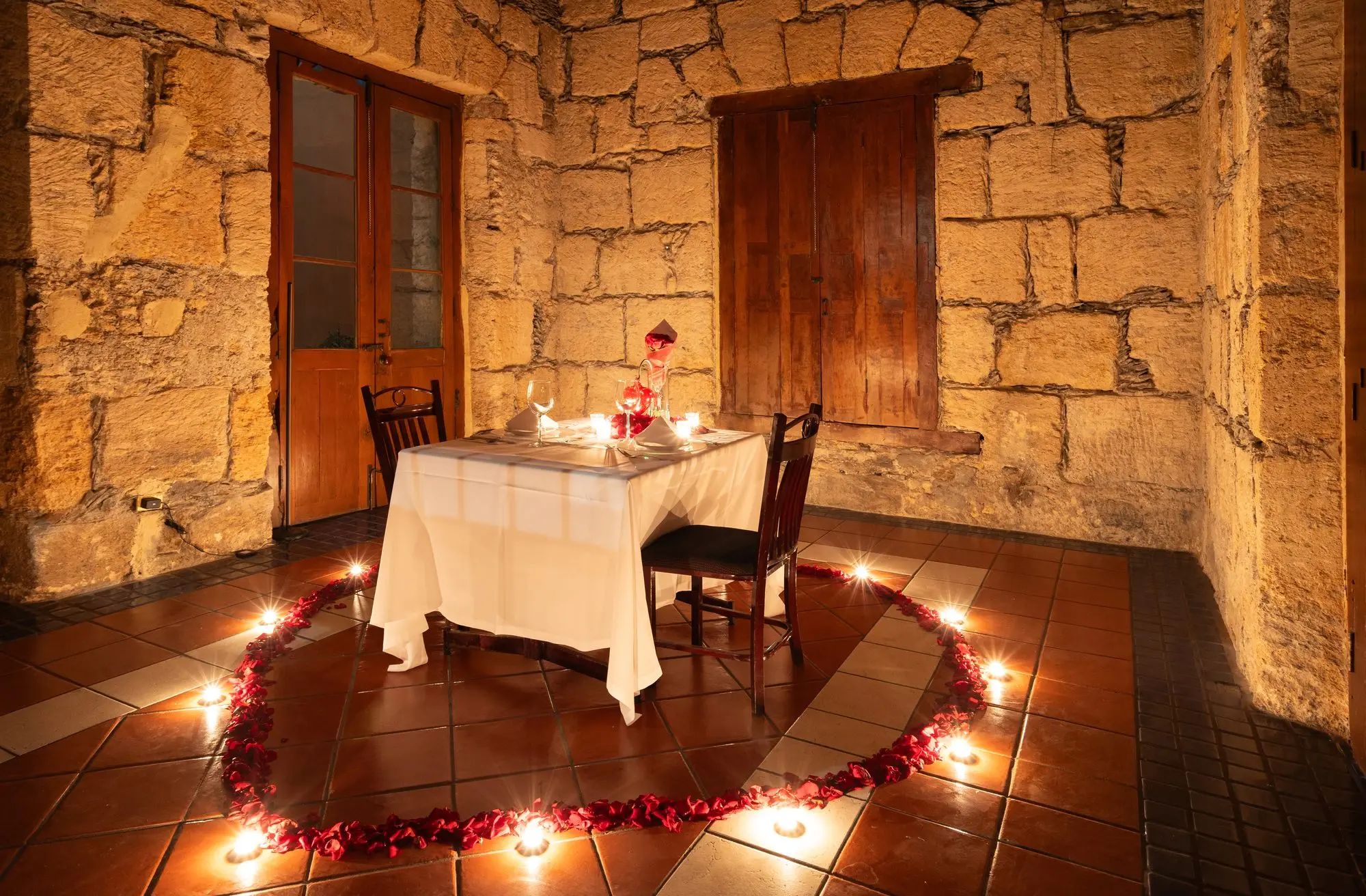 The table for two of the romantic setup, ringed by the heart of candles